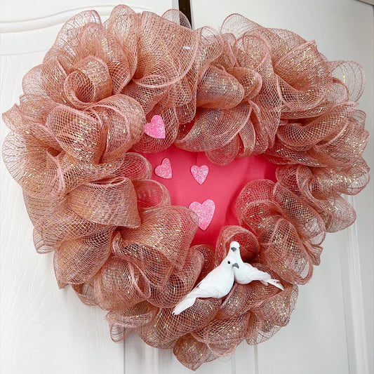 Romantic pink heart shaped wreath with birds