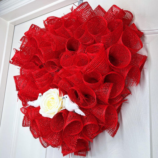 Heart shaped wreath with rose and birds